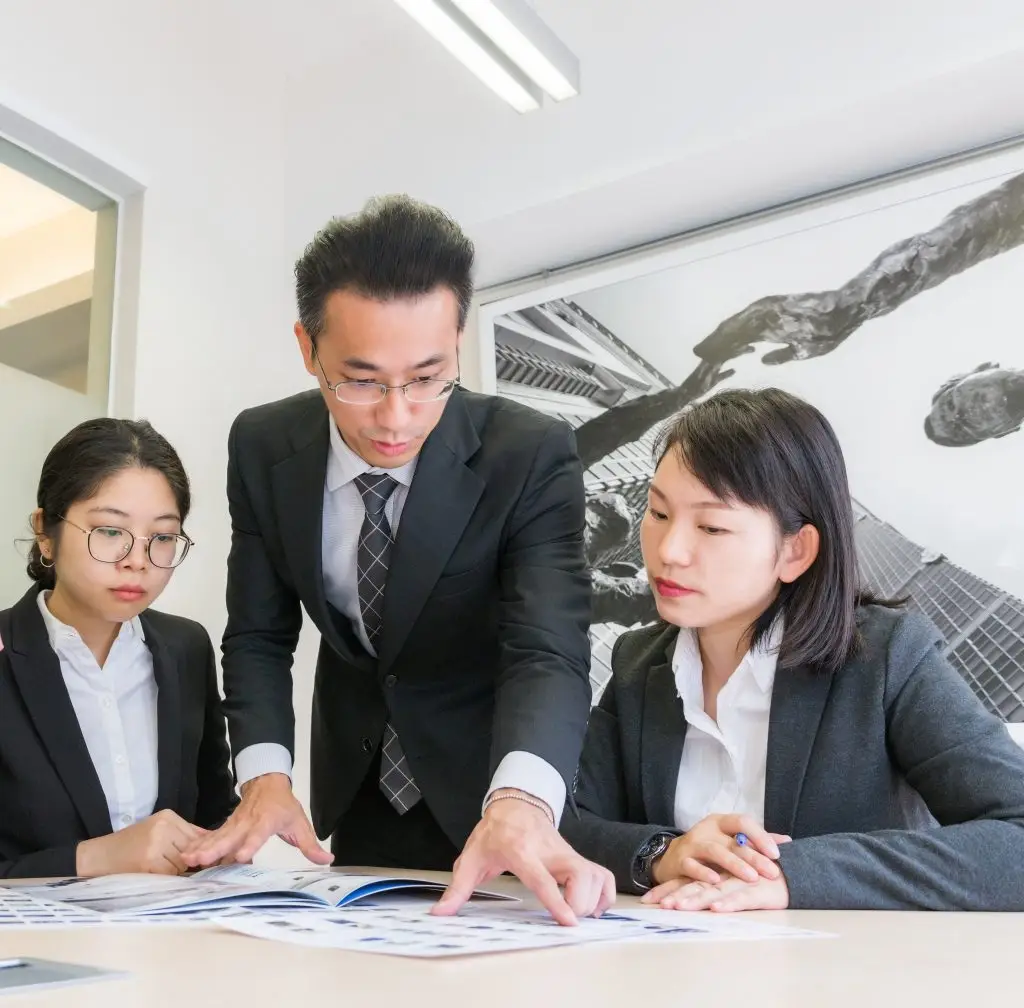 three employees in an office meeting Melchers Taiwan