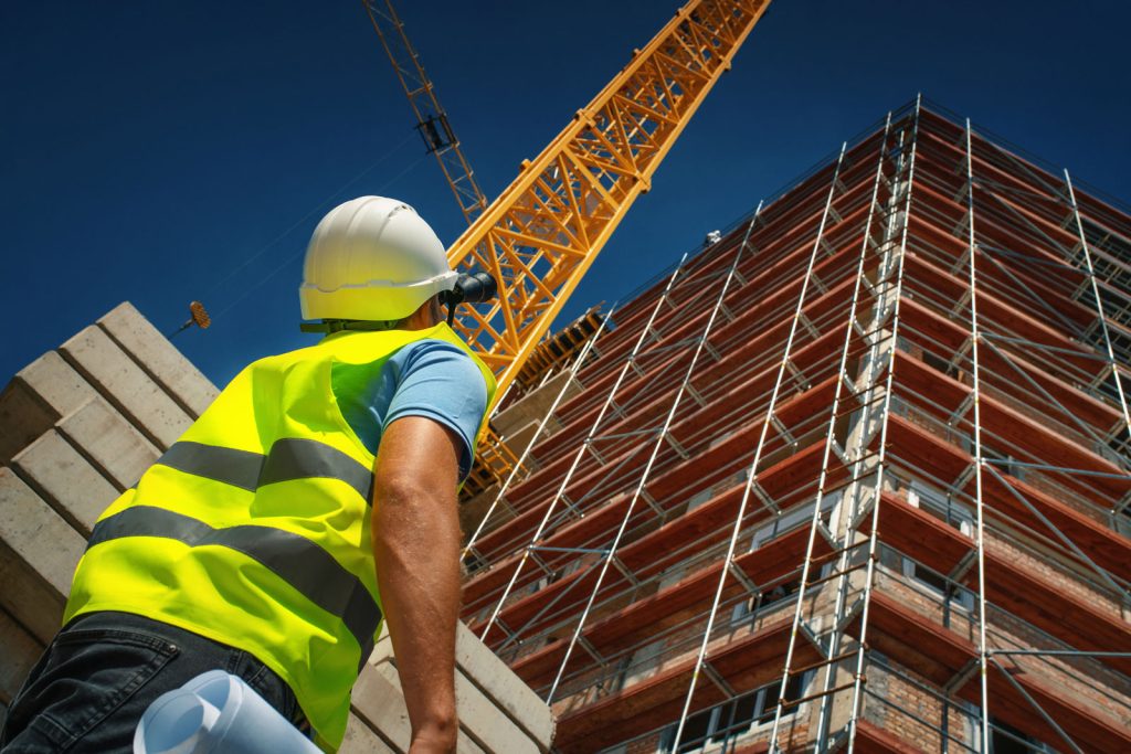 construction worker at a construction site looking up a building Melchers Taiwan